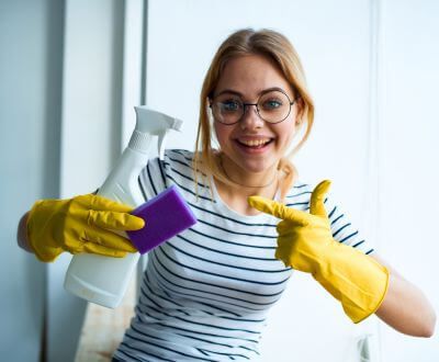 Woman with sprayer and sponge