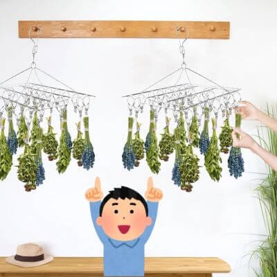 2 Elesunory racks hanging up with herbs hanging from them.