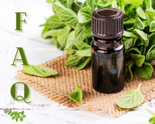 Bottle of oregano oil with fresh oregano on  woven placemat with FAQ on left in green