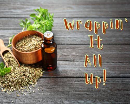 Both fresh oregano, dried oregano, and bottle of oregano oil on table with "Wrappin' It All Up!" on right